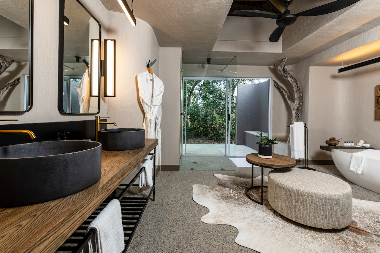 <p>The Suites at Sabi Sabi Bush Lodge are spacious and beautifully decorated with African-inspired furnishings and decor. Each room is equipped with modern amenities, including air conditioning, ceiling fans, and en-suite bathrooms with both indoor and outdoor showers.</p>  <p>The rooms also feature private decks with stunning views of the surrounding bushveld, providing guests with the opportunity to spot wildlife from the comfort of their own room.</p>  <p>Overall, the bedrooms at Sabi Sabi Bush Lodge offer a luxurious and unforgettable safari experience.</p>